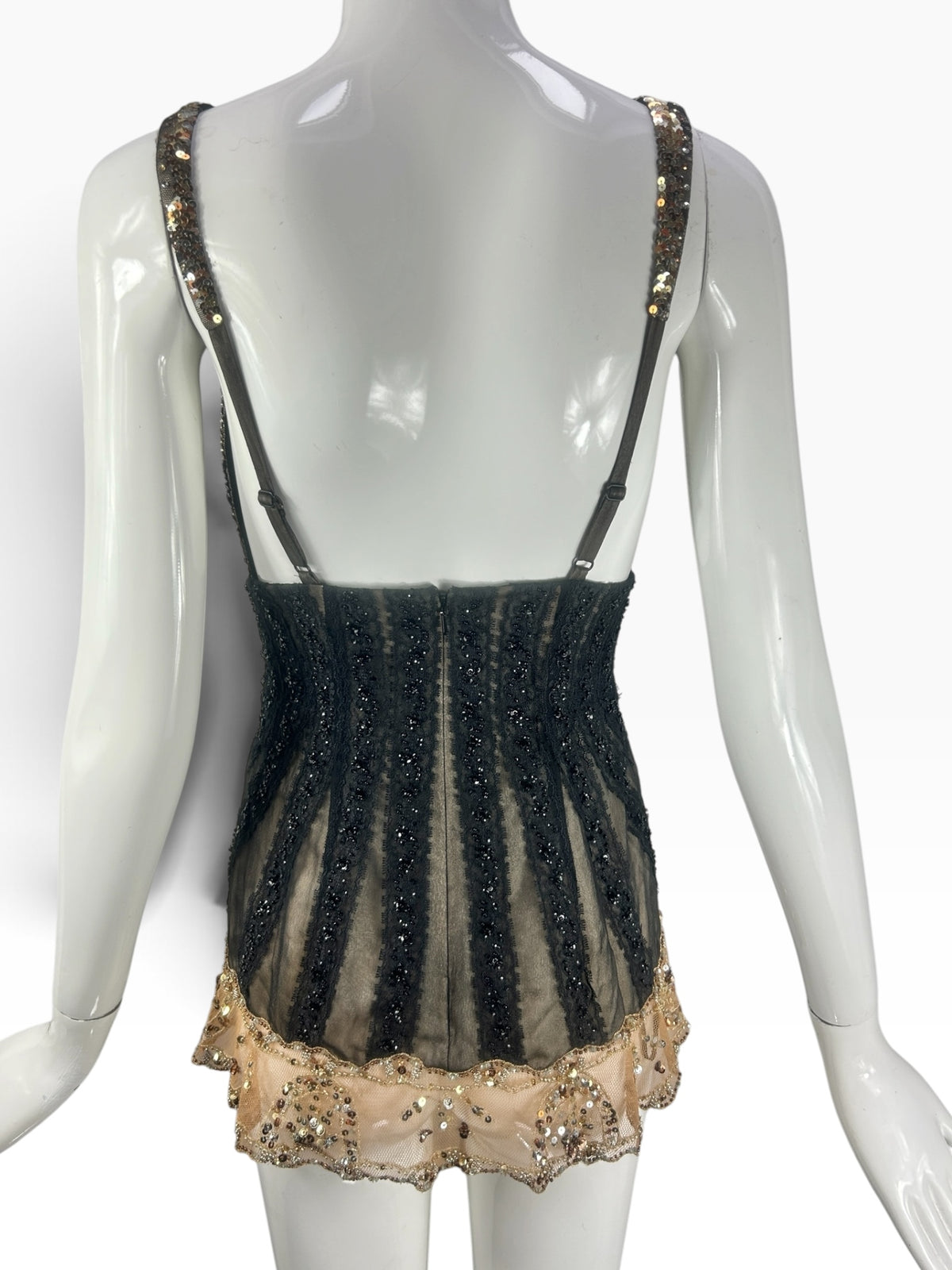 Back view of Cannonball and Tilly black lace corset bodysuit with vertical beaded panels and gold sequin hem