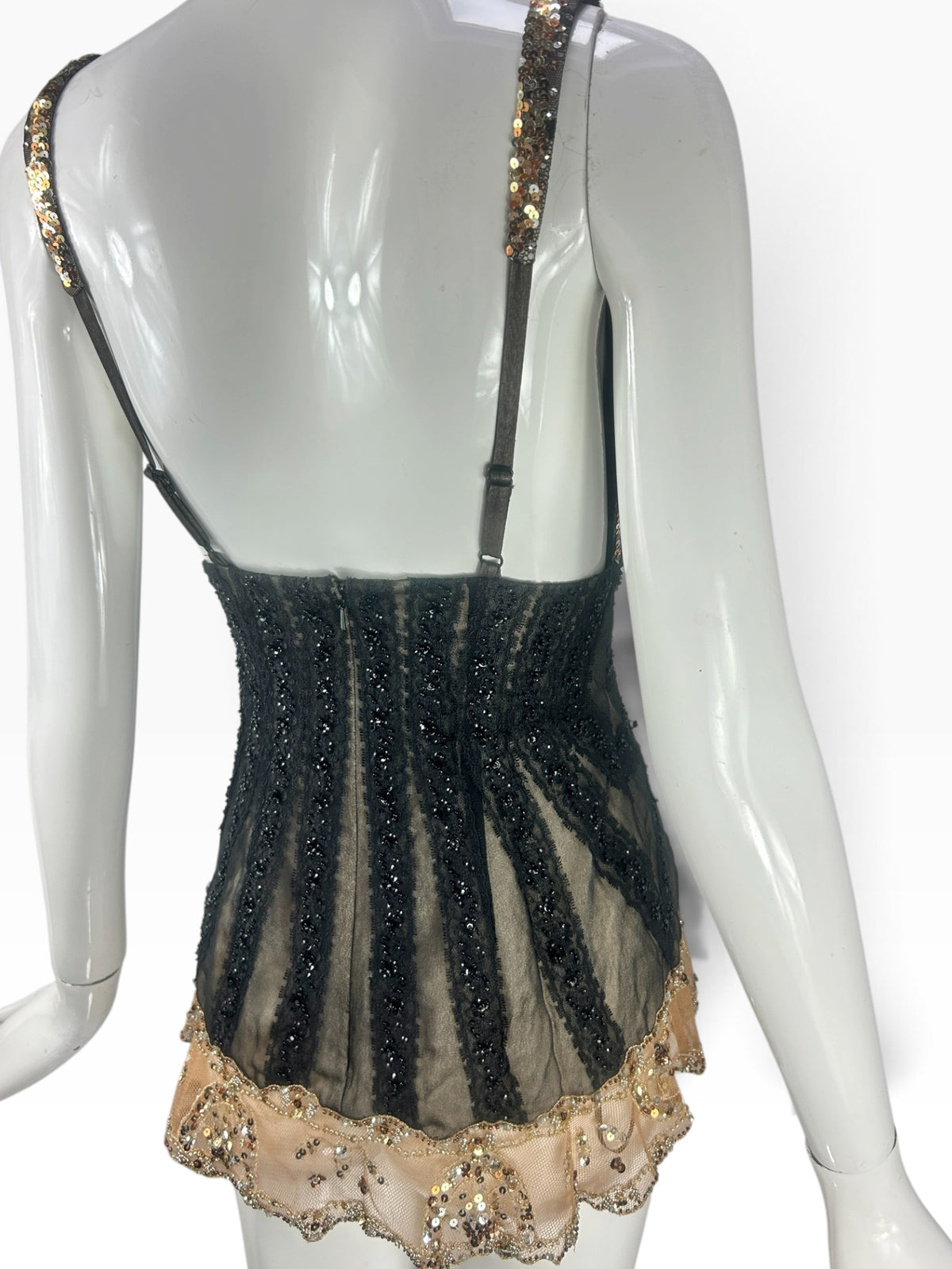 Cannonball and Tilly black lace corset bodysuit with gold sequin scalloped hem and beaded vertical panels, back view.